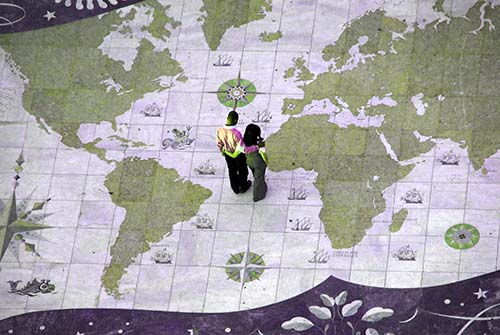 couple stands on world map contemplating futurethe